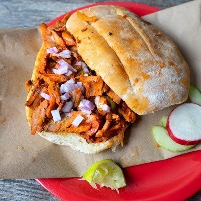 Mexican food: pork sandwich also known as "torta al pastor" on wooden background