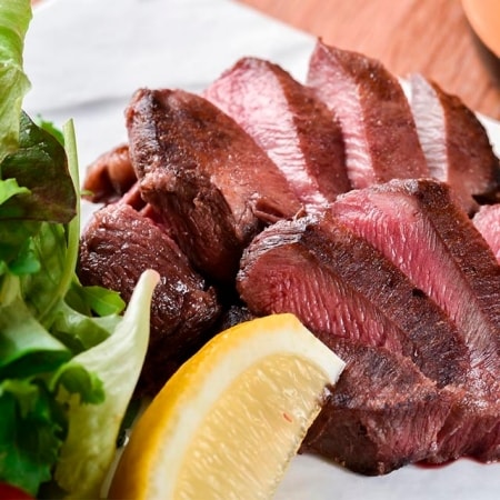 tacos de lengua de res con cebolla, guacamole y hojas de cilantro