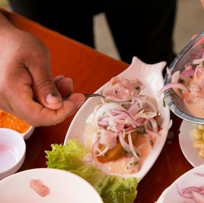 Preparing a delicious Peruvian sea bass ceviche in the fishing port of ChorrÃ­os in Lima.
