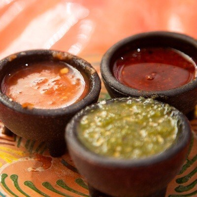 Handmade clay plate with 3 different types of Mexican hot sauces..