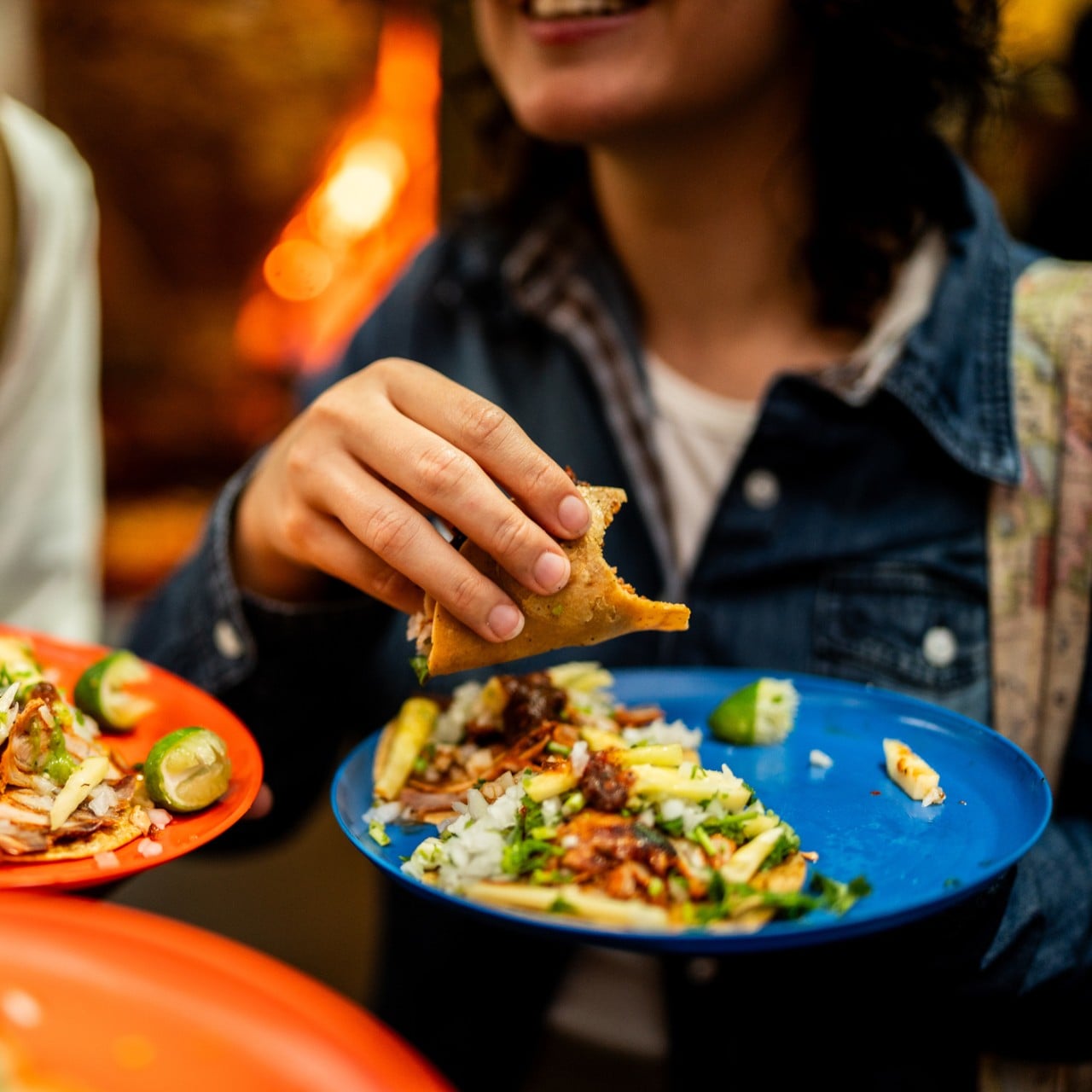 Close-up of friends eating taco outdoors