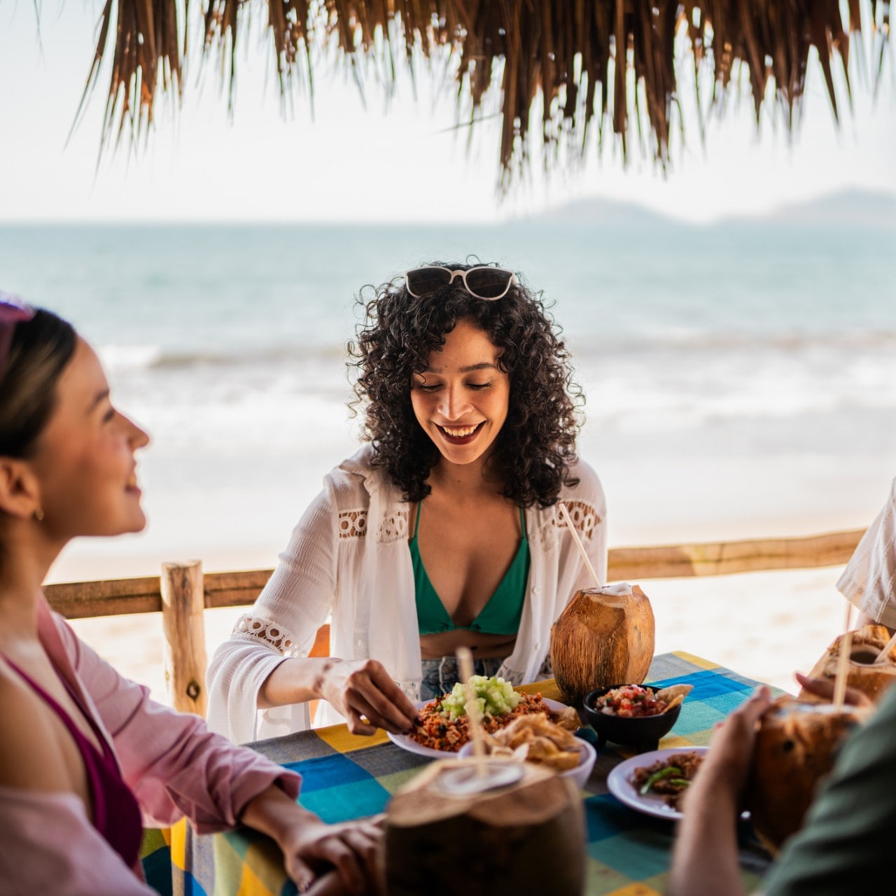 Friends talking in restaurant on the beach